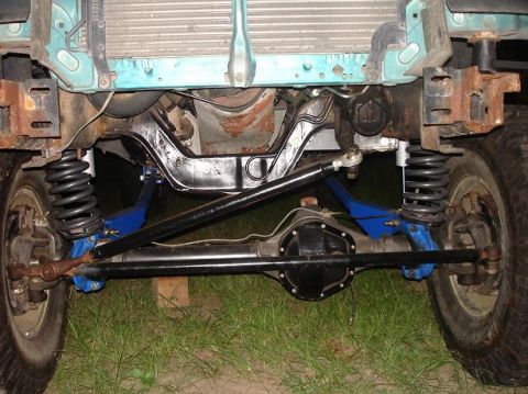 1996 Ford F-150 - Front suspension and differential of a 1996 Ford F-150, modified with blue control arms and aftermarket shocks.