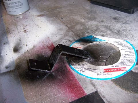 1991 Ford Bronco - A black metal bracket rests on a grinding wheel, with visible text indicating MAX.RPM 13,200.