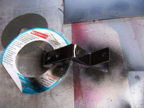 1991 Ford Bronco - Metal bracket and grinding wheel with warning labels visible.