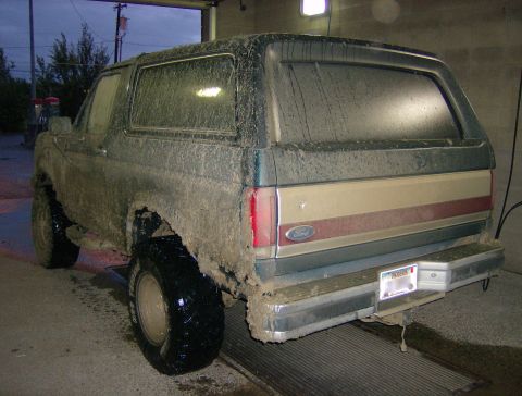 1990 Ford Bronco - This mud-covered 1990 Ford Bronco is seen from the rear at a wash bay.