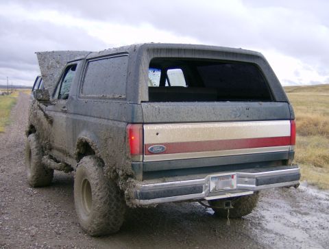 1990 Ford Bronco - This 1990 Ford Bronco is heavily covered in mud, suggesting it has been off-roading.