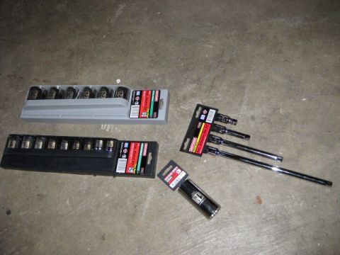 1995 Ford Bronco - A collection of Craftsman sockets and extensions are laid out on a concrete surface.