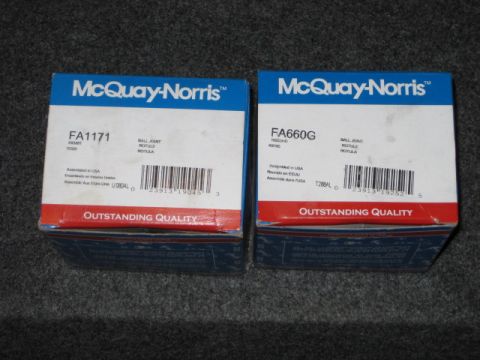 1995 Ford Bronco - Two McQuay-Norris ball joint boxes are displayed on a textured surface.