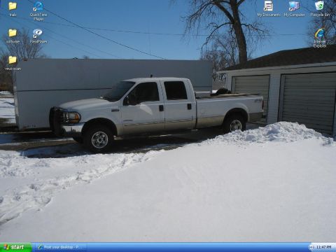 2000 Ford F-250 - White 2000 Ford F-250 crew cab pickup truck parked in snow next to a garage.