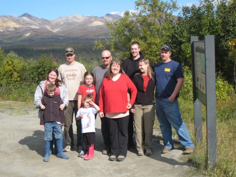 2000 Ford E350 - A family poses for a photo in a scenic outdoor location with mountains in the distance.