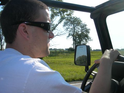 1991 Jeep Wrangler - Driving a 1991 Jeep Wrangler on a sunny day, with trees reflected in the side mirror.