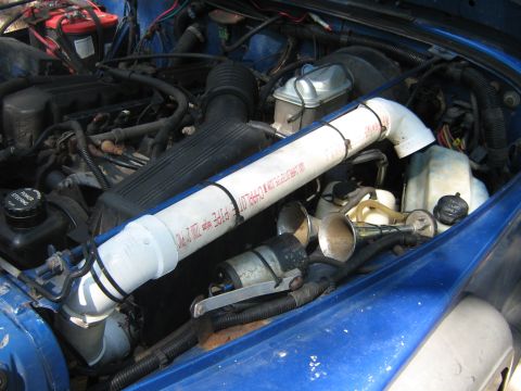 1990 Ford Bronco - The engine bay features a custom air intake system made of PVC pipe and dual horns.