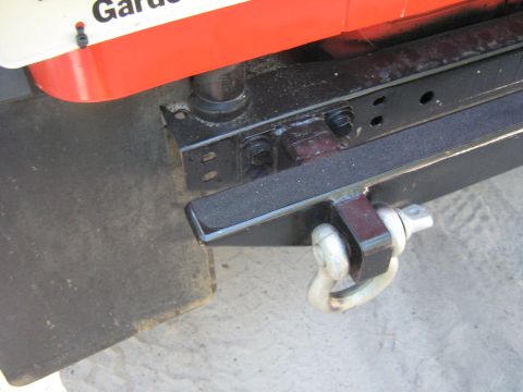 1990 Ford Bronco - Tow hitch receiver and shackle shown in detail, with partial text visible on an adjacent panel.