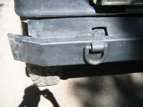 1990 Ford Bronco - Rear bumper detail showing a tow hook and part of a tire.