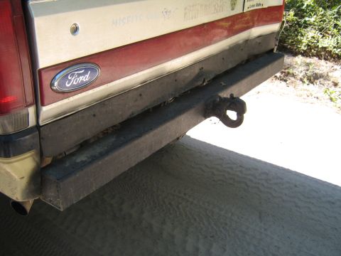 1990 Ford Bronco - The rear of a Ford Bronco shows a tow hitch and a red stripe above the bumper.