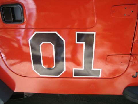 1990 Ford Bronco - Close-up of the side of an orange vehicle showing the number 01 in a distinctive font.