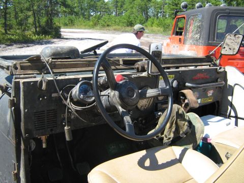 1990 Ford Bronco - Interior of a Jeep CJ, with another vehicle in the background.