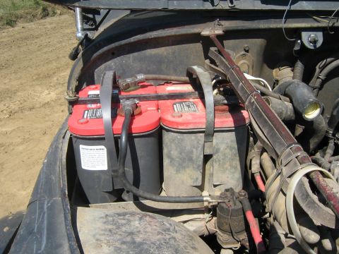 1990 Ford Bronco - Dual Optima batteries are mounted in the engine bay, connected by wiring and straps.
