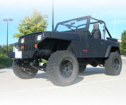 1991 Jeep Wrangler - Modified 1991 Jeep Wrangler parked outdoors on a sunny day.