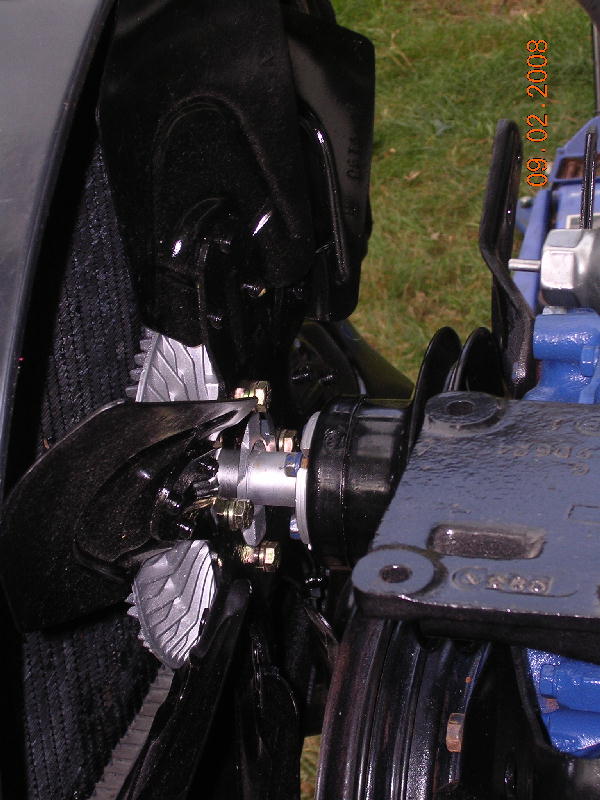 Close-up of engine fan blades, pulley, and radiator grille. Date stamp 09.02.2008 visible