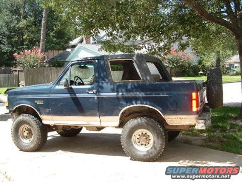 1991 Ford Bronco - Side view of a blue 1991 Ford Bronco, showing its body style and removable top.