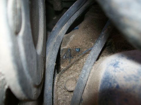1975 Ford Ranchero - Close-up view of an engine block with a visible number 4 and a CARQUEST hose.
