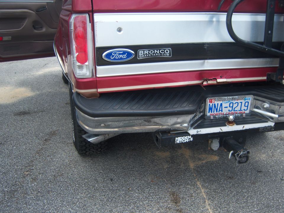 Red 1994 Ford Bronco rear bumper with license plate WNA-9219, tow hitch, and "BroncoGraveyard.com" badge