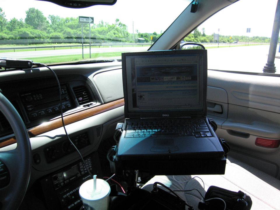 2001 Ford Crown Victoria interior showing dashboard, laptop, and cup
