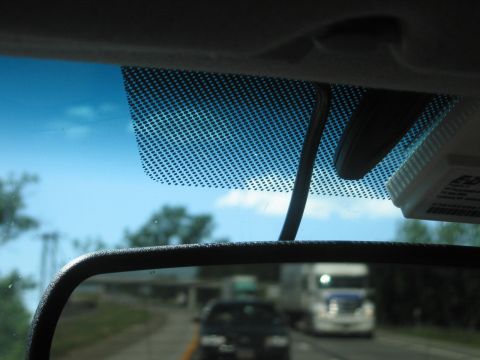 2001 Ford Crown Victoria - Highway driving scene viewed from inside a vehicle, with other cars and trucks on the road.