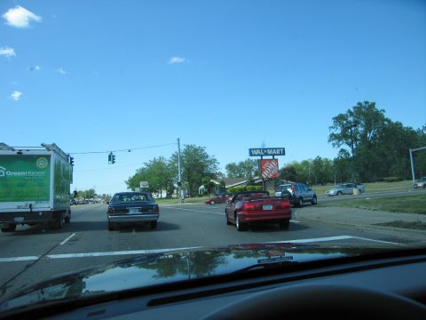 2001 Ford Crown Victoria - A dark sedan is seen from behind on a street with a Wal-Mart sign in the distance.