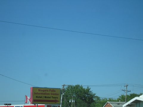 2001 Ford Crown Victoria - Sign for Niagara Falls Information Center, Hotel, and Motel Tours.