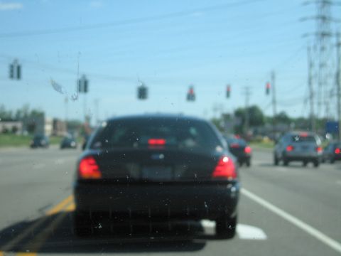 2001 Ford Crown Victoria - Rear view of a black 2001 Ford Crown Victoria driving on a highway.