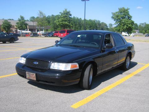 2001 Ford Crown Victoria - Black 2001 Ford Crown Victoria sedan parked in a lot on a sunny day.