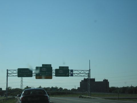 2001 Ford Crown Victoria - Highway scene with overhead signs indicating directions to Canada and various routes.