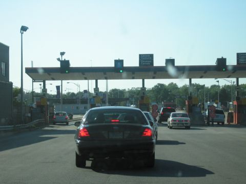 2001 Ford Crown Victoria - Vehicles queue at a Canada Customs border crossing under a bright, clear sky.