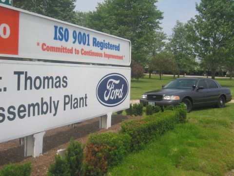 2001 Ford Crown Victoria - A dark 2001 Ford Crown Victoria is parked on the grass near the St. Thomas Ford Assembly Plant sign.
