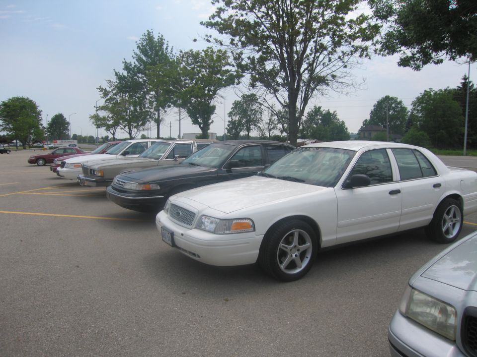 White 2001 Ford Crown Victoria parked in a lot, front 3/4 view