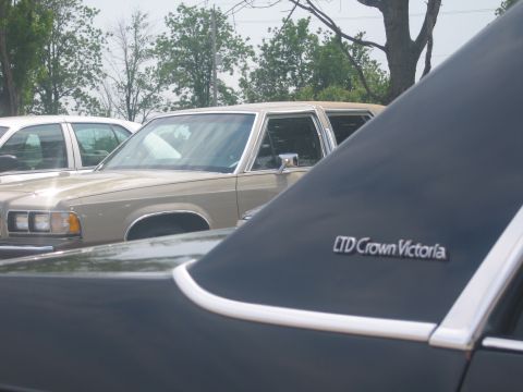 2001 Ford Crown Victoria - A tan Ford LTD Crown Victoria is seen parked next to another vehicle.