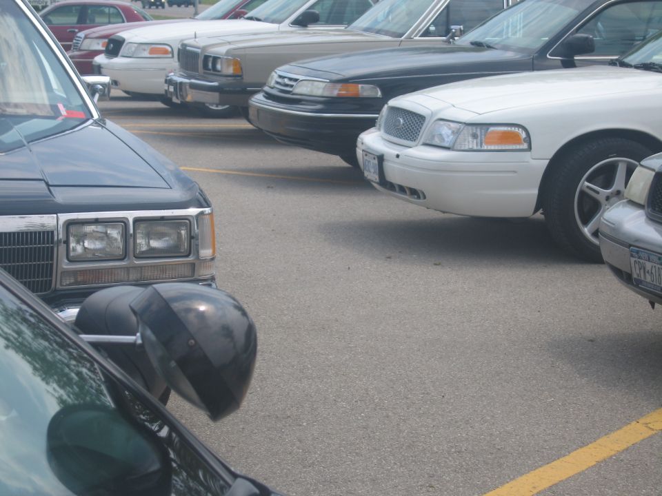 White 2001 Ford Crown Victoria front corner, parked in a lot