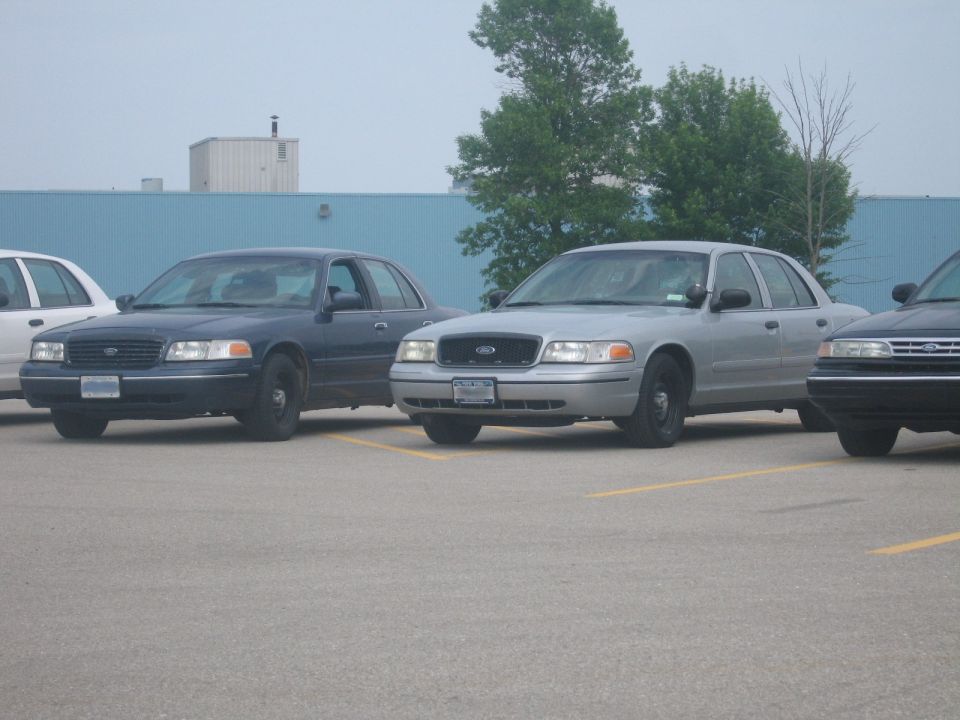 Silver 2001 Ford Crown Victoria parked in a lot, front view