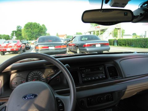 2001 Ford Crown Victoria - Photo from inside a Ford showing the dashboard and steering wheel with traffic ahead.