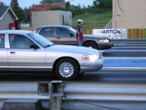 2001 Ford Crown Victoria - Photograph of Ford Crown Victoria sedans at a dragstrip, not a technical document.