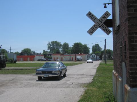 2001 Ford Crown Victoria - Photo of a blue Ford sedan near a railroad crossing sign, not a technical document.