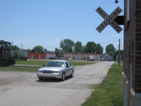 2001 Ford Crown Victoria - Photo of a silver Ford Crown Victoria by a railroad crossing, not a technical document.
