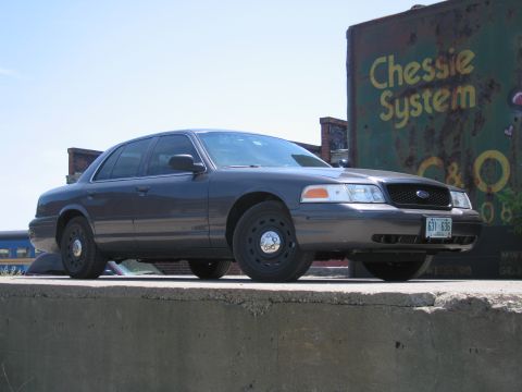 2001 Ford Crown Victoria - 2001 Ford Crown Victoria parked outdoors with a train car visible behind it.