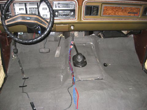 1979 Ford Bronco - Interior view of a 1979 Ford Bronco, highlighting the dashboard and floor shifter with wiring visible.