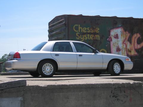2001 Ford Crown Victoria - Side profile of a silver 2001 Ford Crown Victoria parked outdoors.