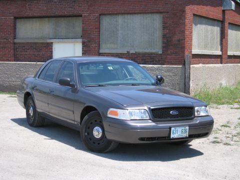 2001 Ford Crown Victoria - Dark gray 2001 Ford Crown Victoria police car with black steel wheels.