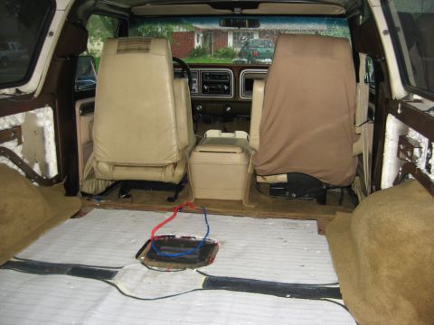 1979 Ford Bronco - Interior view of a 1979 Ford Bronco with flooring removed, revealing wiring and insulation.