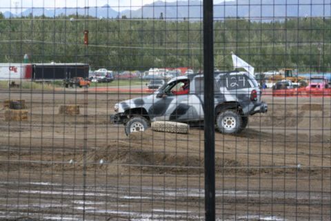 1975 Toyota Land Cruiser - A camouflaged SUV with the number 124 painted on its side competes in a demolition derby.