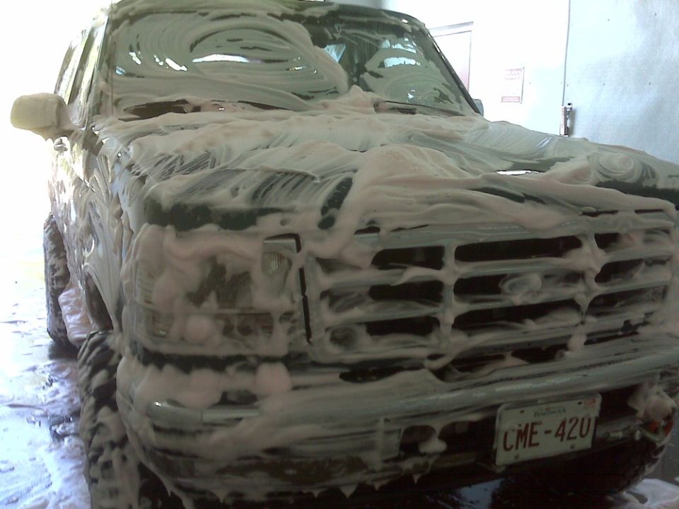 1996 Ford Bronco front grille covered in soap suds, license plate CME-420 visible