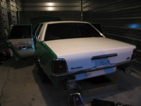 1991 Ford LTD Crown Victoria - This 1991 Ford Crown Victoria LTD is shown with its rear end and open doors, parked indoors.