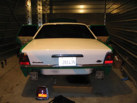 1991 Ford LTD Crown Victoria - The rear of a 1991 Ford Crown Victoria LTD is shown, with its doors open and some green trim visible.