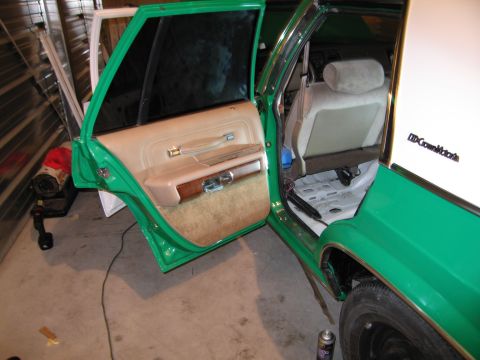 1991 Ford LTD Crown Victoria - Interior view of a green sedan with tan upholstery and open doors, revealing exposed wiring and floor components.