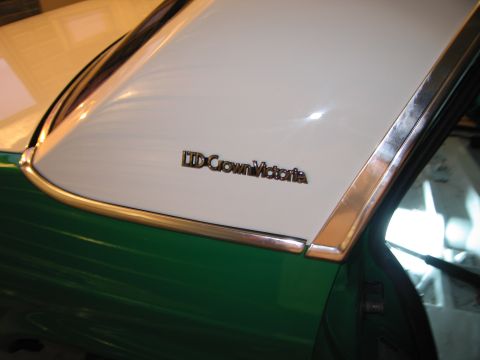 1991 Ford LTD Crown Victoria - The chrome trim surrounds the LTD Crown Victoria emblem on the car's white roof panel.